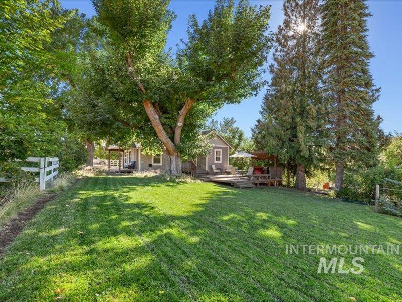 2651 Fruitvale Glendale Road Council, ID 83612 - Photo 20 of 24 Manicured lawn with mature trees and a white picket fence bordering the property