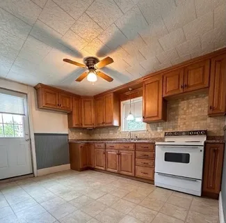 a kitchen with stainless steel appliances granite countertop a stove sink and cabinets