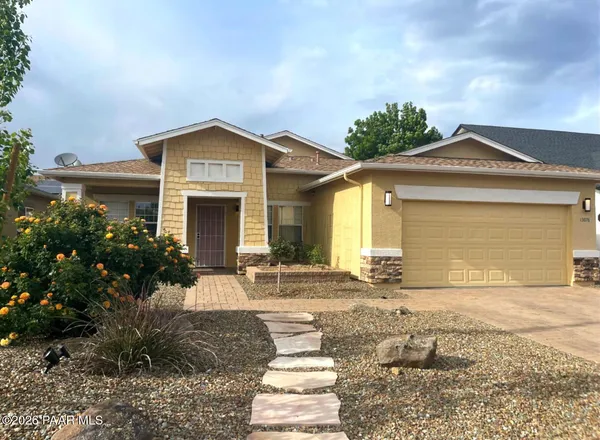 a kitchen with stainless steel appliances granite countertop a refrigerator a sink and a stove