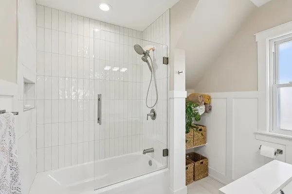 a bath room with a bath tub and a shower