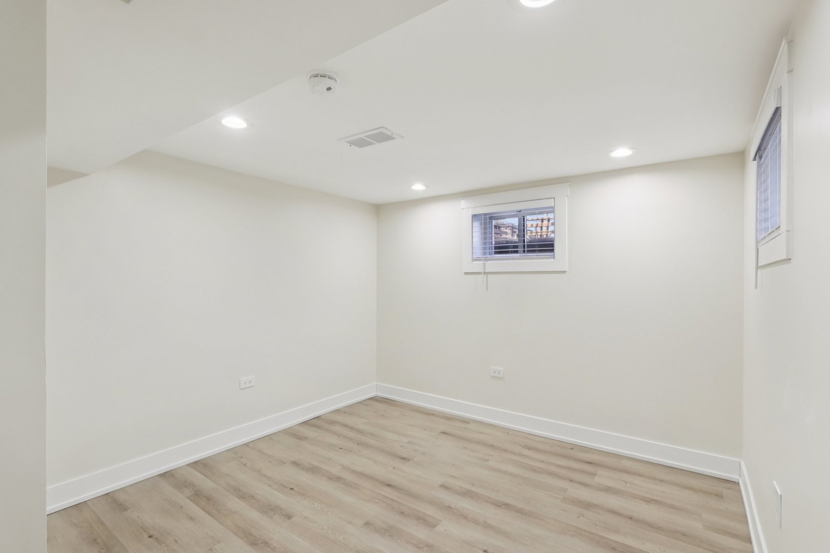6014 West Fletcher Street Chicago, IL 60634 - Photo 20 of 33 an empty room with wooden floor and window