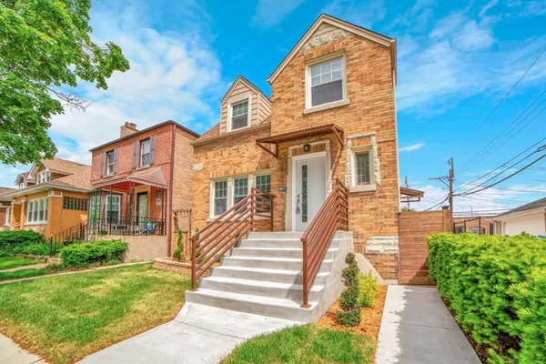 a view of a brick house with a yard