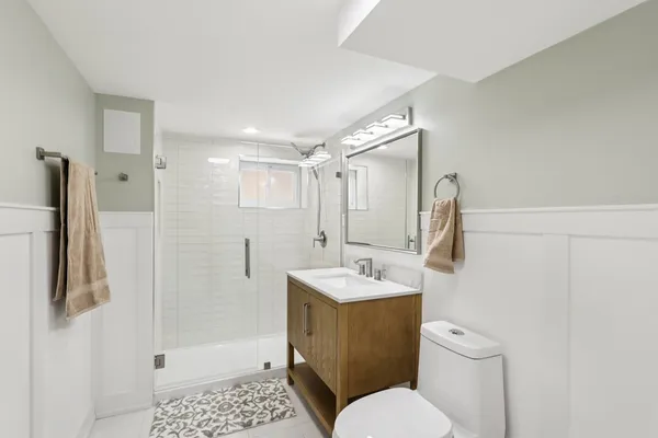 a bathroom with a sink toilet and shower
