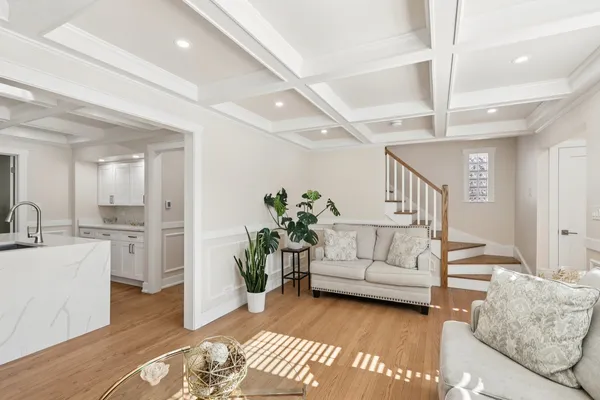 a living room with furniture and a chandelier