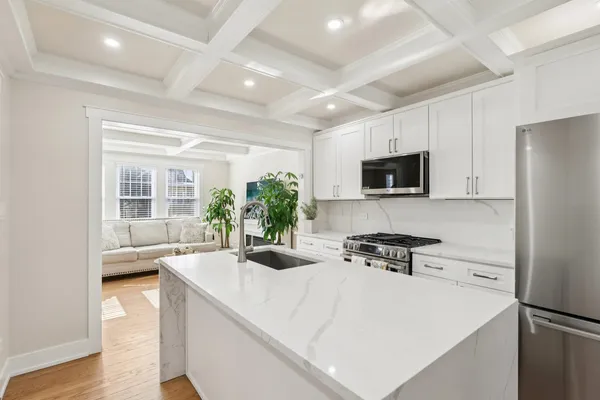 a kitchen with a sink a counter top space and stainless steel appliances