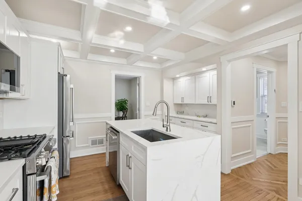 a kitchen with a sink stove and refrigerator