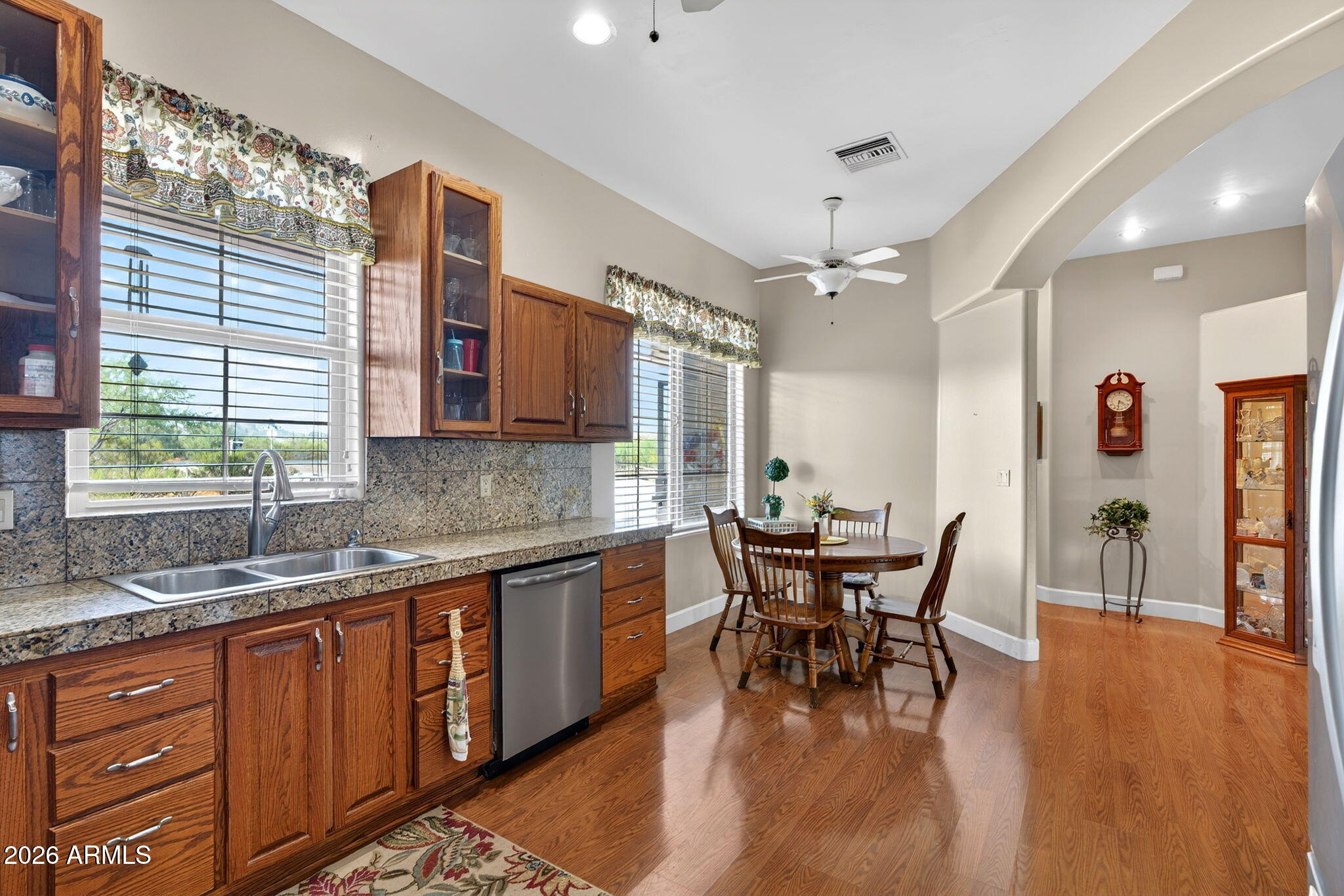 2929 West New River Road New River, AZ 85087 - Photo 13 of 53 a dining room with stainless steel appliances granite countertop wooden floor a dining table and chairs