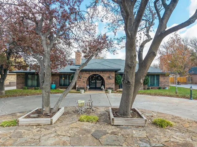 a front view of a house with a yard garage and outdoor seating