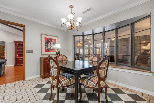 a bedroom with furniture and a large window
