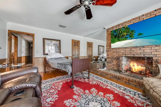 a view of a dining room with furniture a chandelier and wooden floor