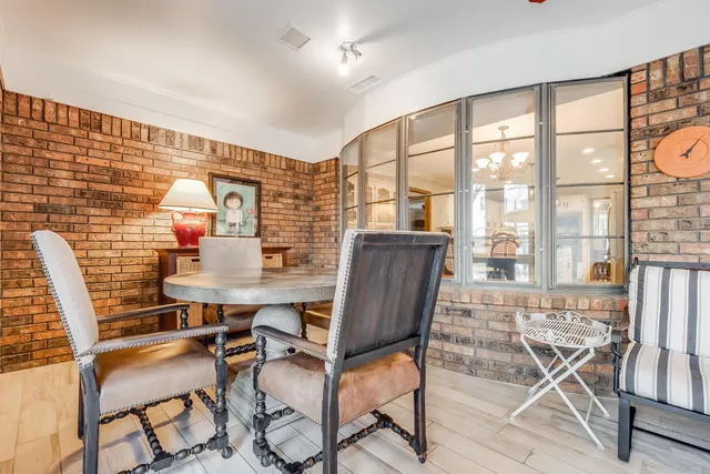 a view of a patio with table and chairs and potted plants