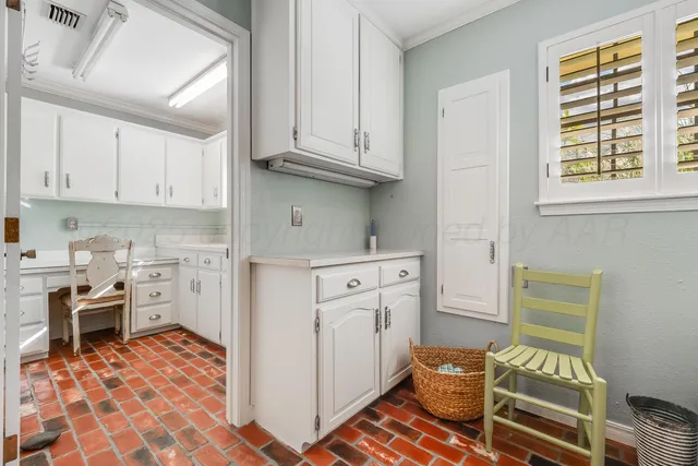 a kitchen with granite countertop wooden cabinets a sink a window and stainless steel appliances