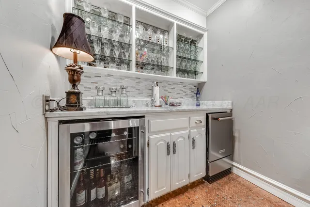 a dining room with furniture a chandelier and wooden floor