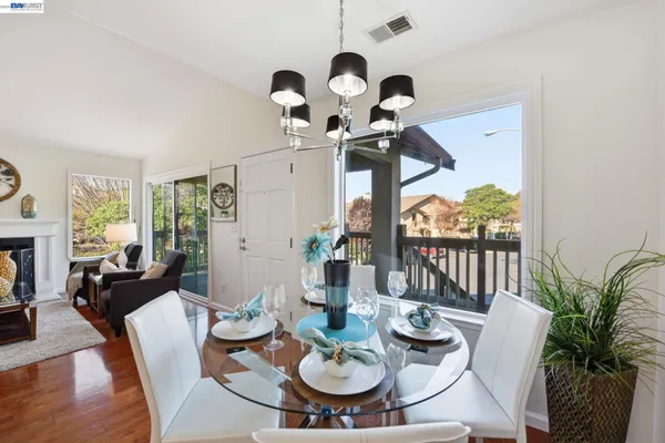 a view of a dining room with furniture wooden floor and chandelier