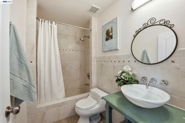 a bathroom with a sink a toilet and a mirror