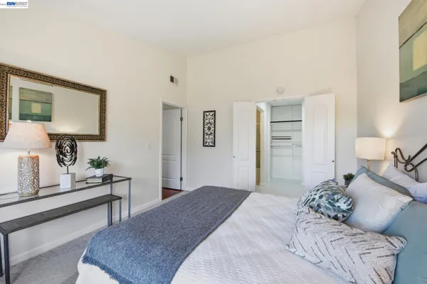 a bedroom with a bed and a dresser