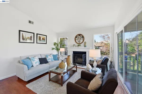 a living room with furniture and a fireplace