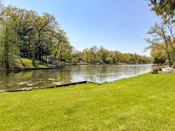 a view of a lake with houses in the back