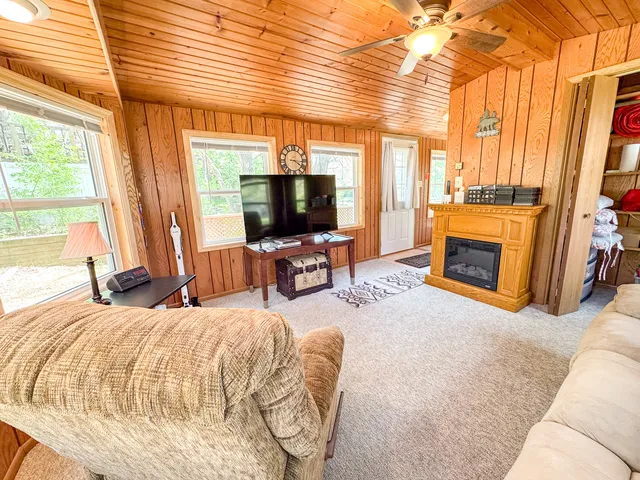 a living room with furniture large window and a fireplace