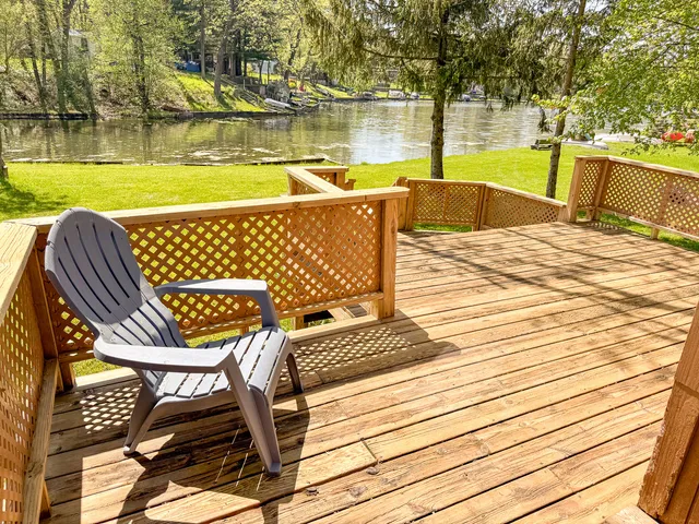 a view of swimming pool with seating space and trees
