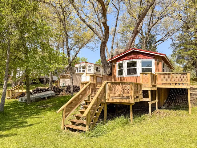 a view of a yard with wooden fence