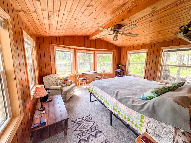 a bed sitting in a bedroom next to a window