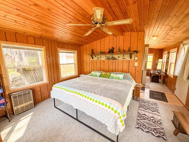 a bed sitting in a bedroom next to a window