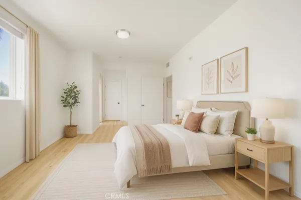 a bedroom with a bed and painting on the wall