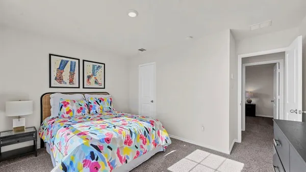 a bedroom with bed and a window