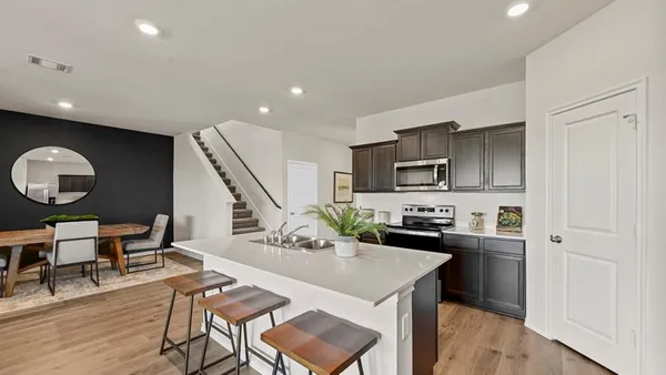 a kitchen with granite countertop white cabinets and stainless steel appliances