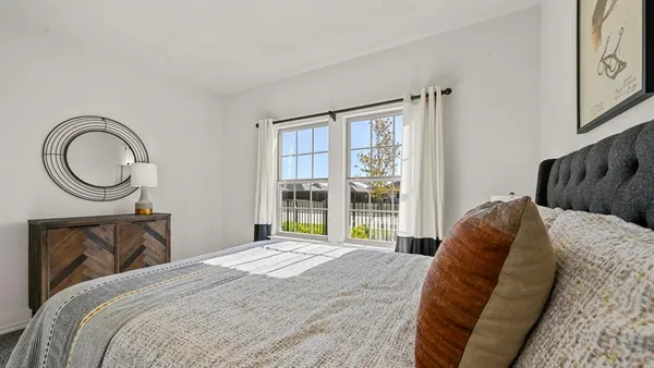 a bedroom with a bed and a painting on the wall