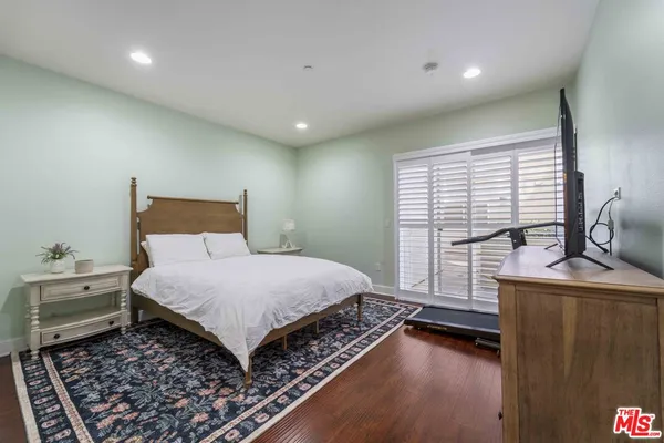 a bedroom with a bed and a large window