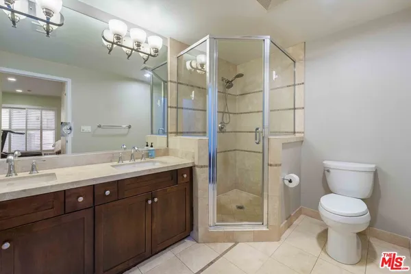 a spacious bathroom with a granite countertop sink toilet and shower
