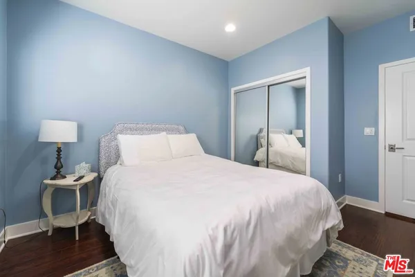 a bedroom with a bed and a lamp on table