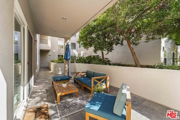 a view of backyard of the house with seating space