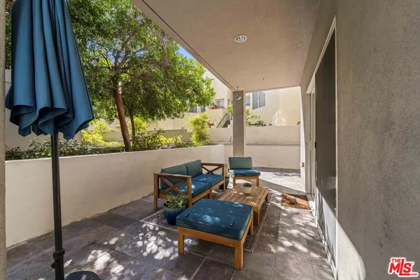 a living room with a couch and a floor to ceiling window