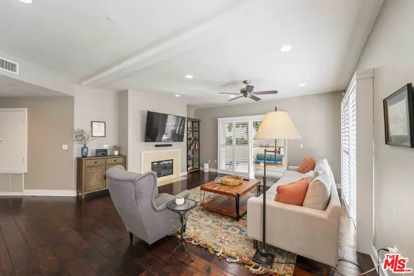 a living room with fireplace furniture and a flat screen tv