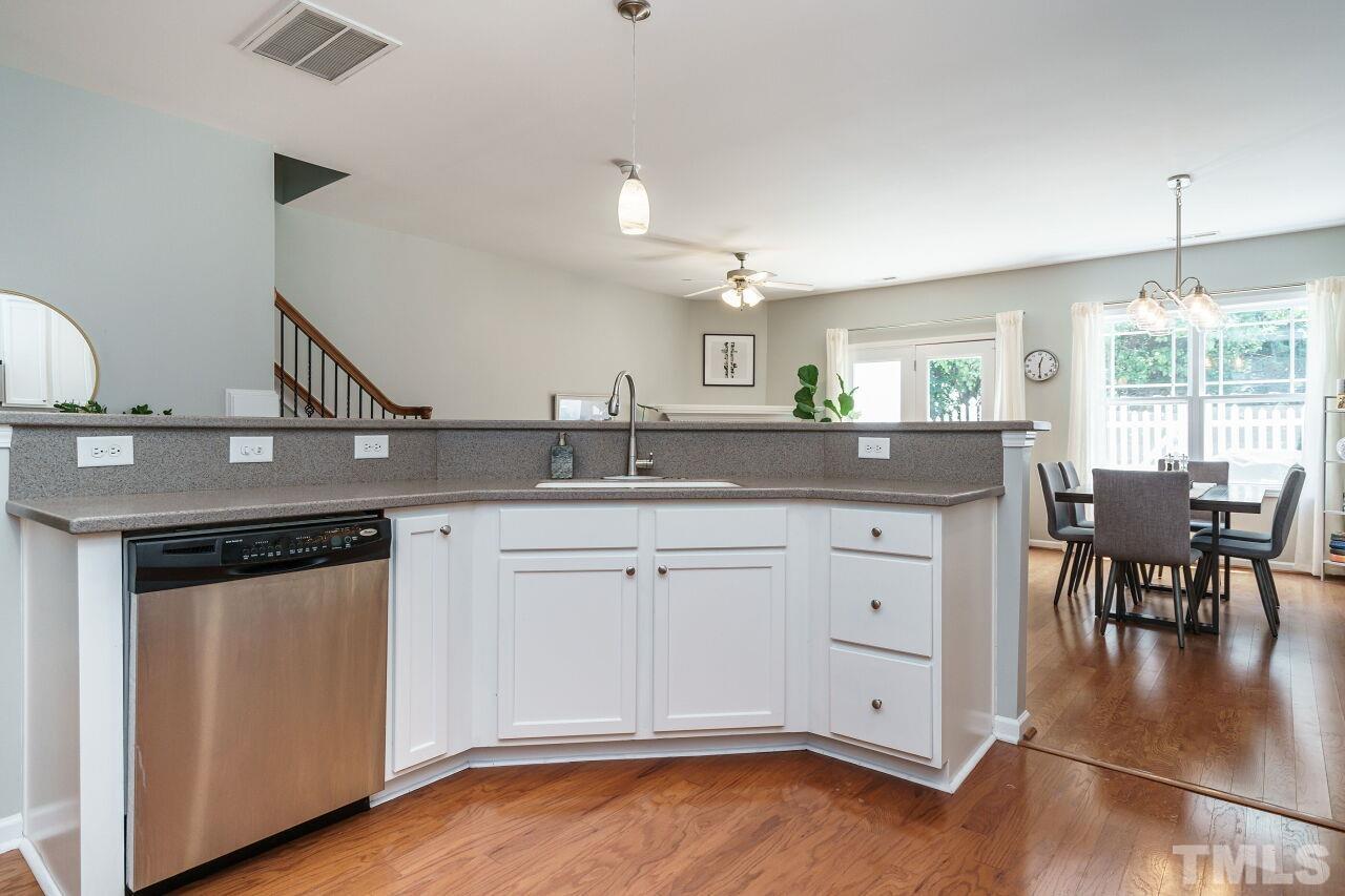 2543 Asher View Court Raleigh, NC 27606 - Photo 12 of 30 Solid surface counters and stainless appliances are found in this well-appointed kitchen.