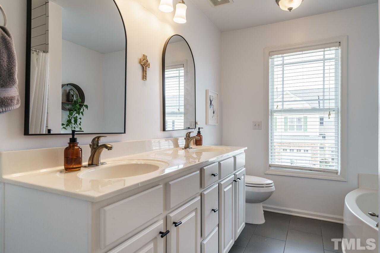2543 Asher View Court Raleigh, NC 27606 - Photo 19 of 30 The master bathroom has a dual vanity and linen closet.