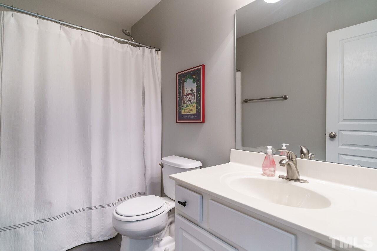 2543 Asher View Court Raleigh, NC 27606 - Photo 24 of 30 The hall bath has a tub/shower combination.