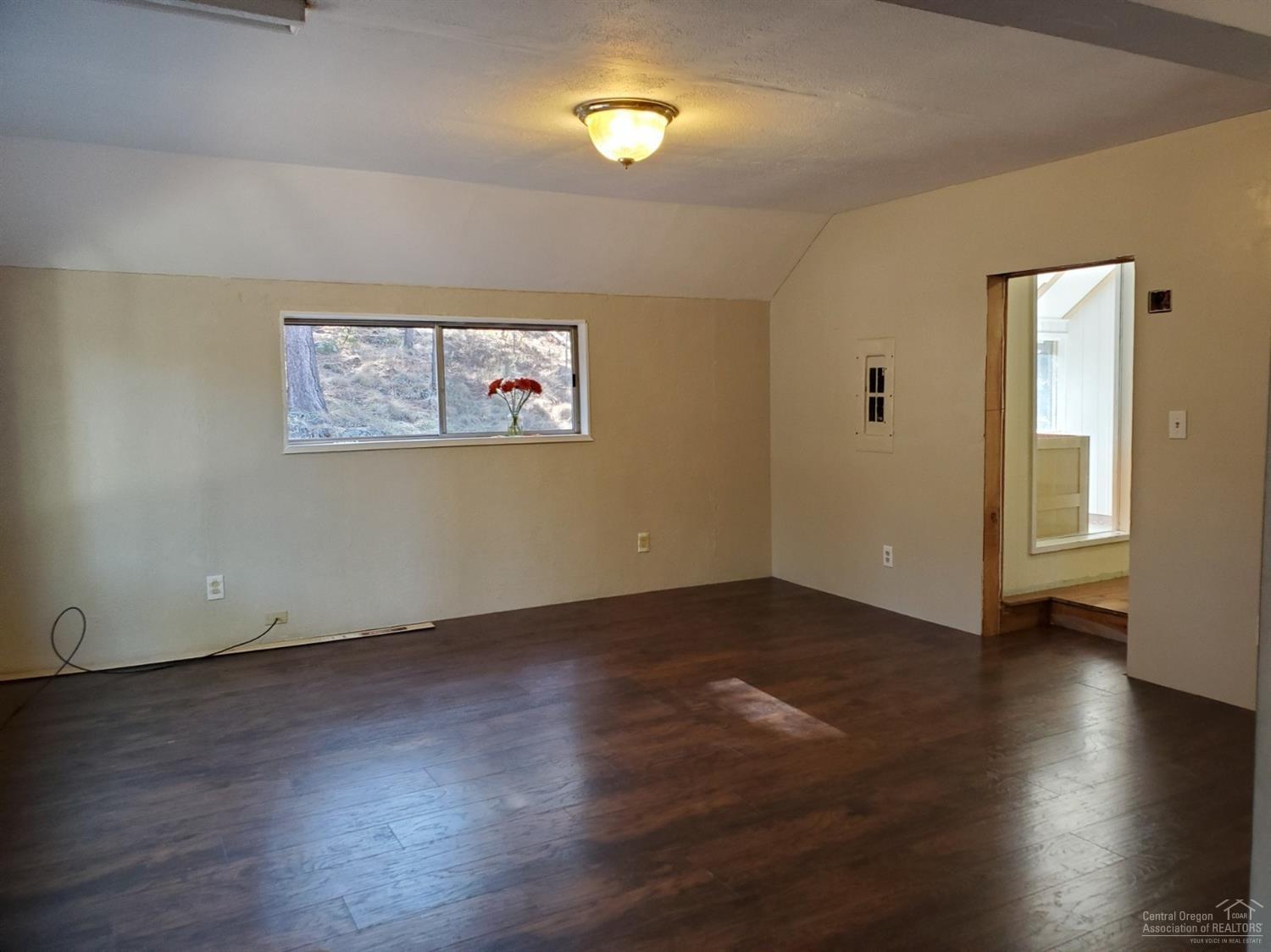 16860 Jacinto Road Bend, OR 97707 - Photo 24 of 24 an empty room with wooden floor and windows