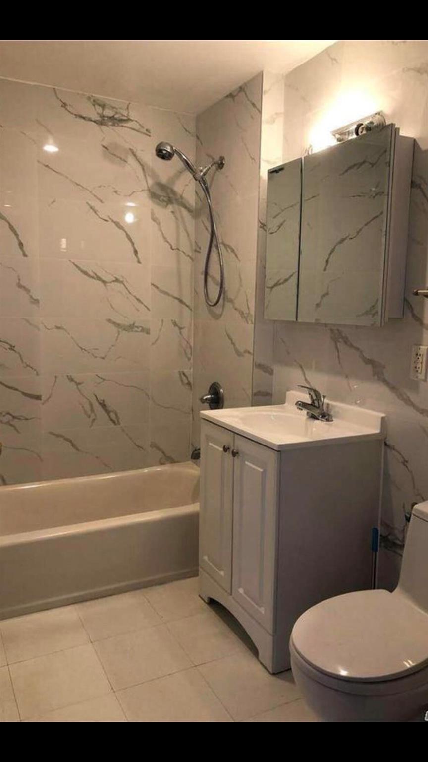 142-28 37th Avenue, Unit 3B Queens, NY 11354 - Photo 3 of 3 a bathroom with a sink a toilet and bathtub