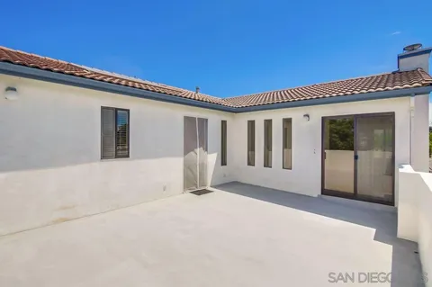 a view of a backyard with plants and a small pool