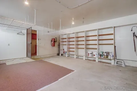 a view of an empty room with wooden floor and closet