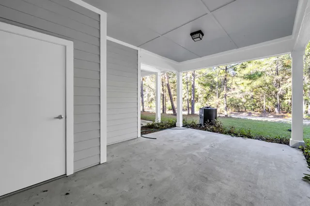a view of a house with porch and garden