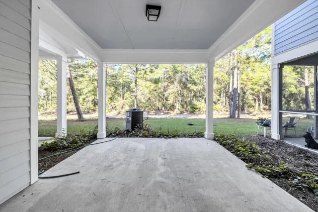 a view of a house with porch and garden