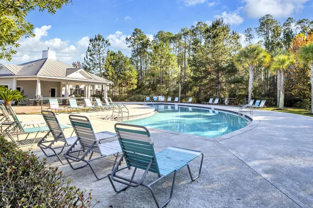 a view of a house with swimming pool and sitting area
