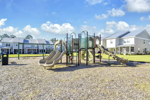a view of a swimming pool with a yard and sitting space