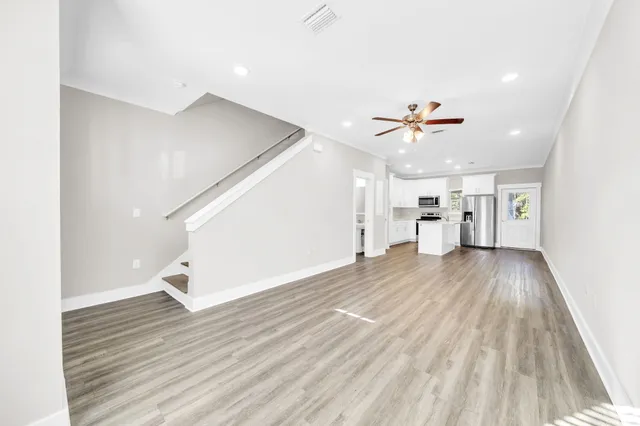 a view of empty room with wooden floor