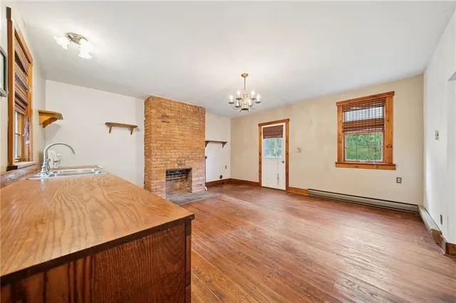 a view of a bedroom with furniture and natural light